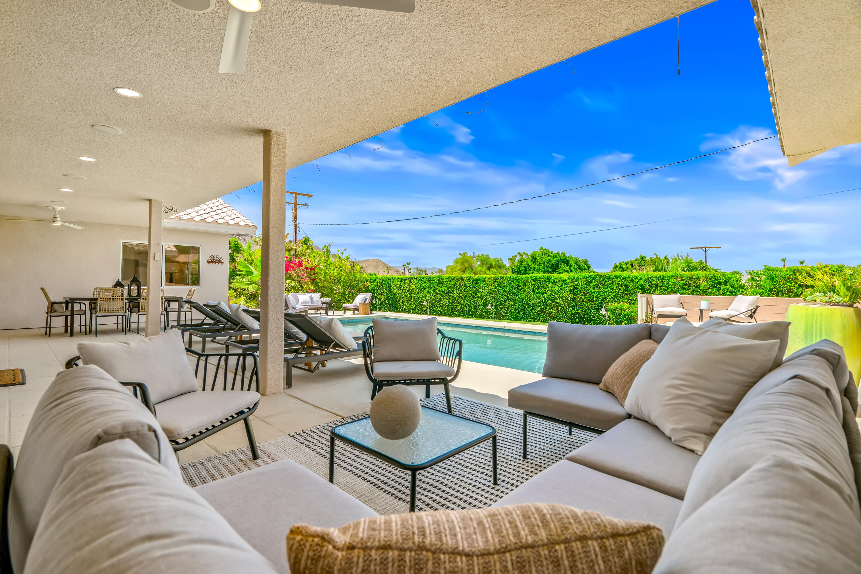 67980 Foothill Road Cathedral City, CA 92234 - Photo 51 of 60 a living room with furniture a rug and a floor to ceiling window