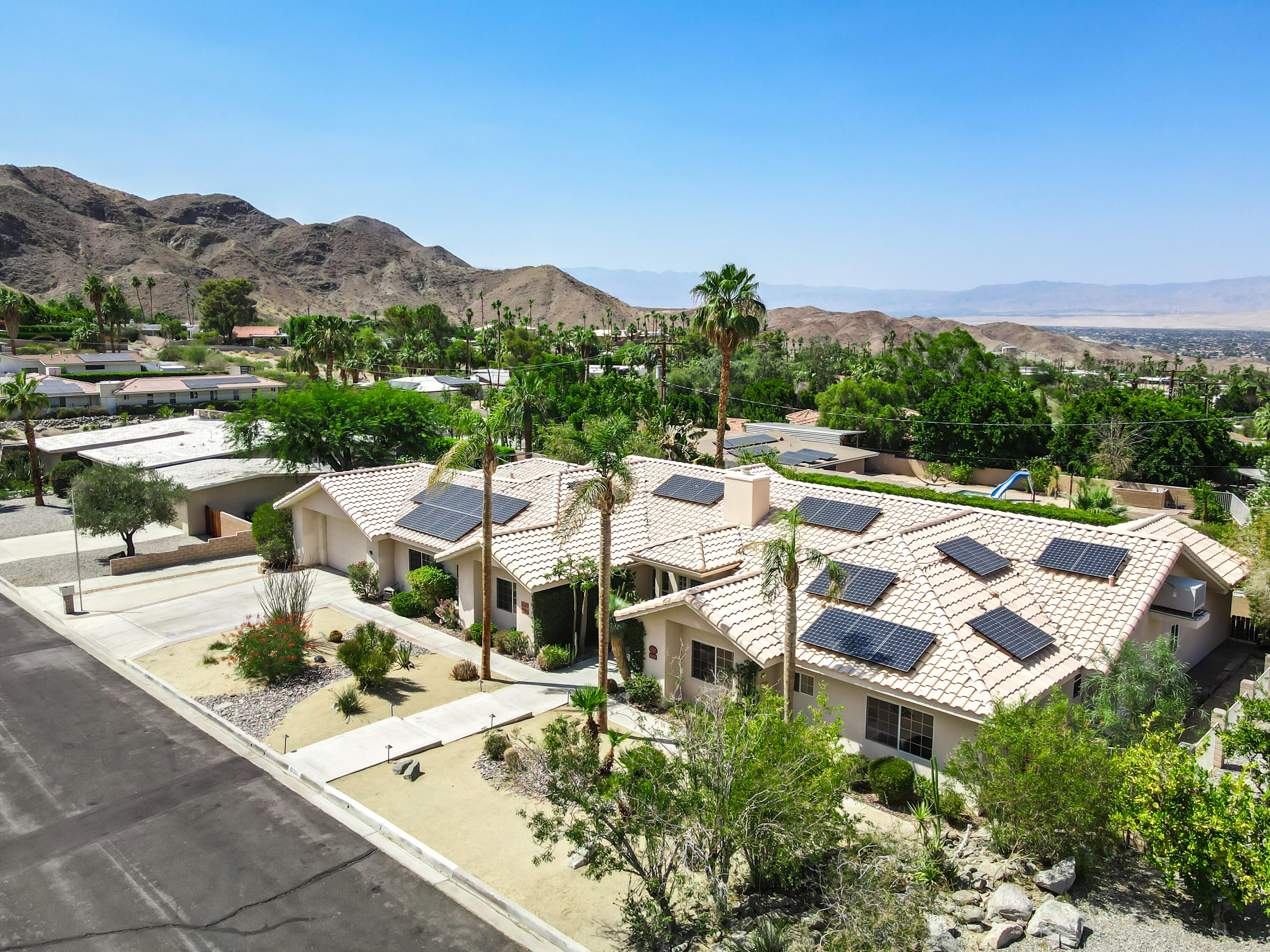 67980 Foothill Road Cathedral City, CA 92234 - Photo 55 of 60 a view of a patio with couches table and chairs under an umbrella