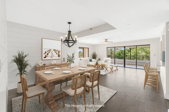 a view of a dining room with furniture wooden floor and chandelier