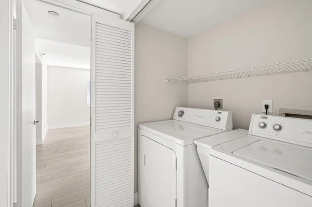 a view of storage and utility room with washer and dryer