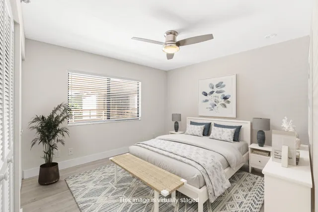 a bedroom with a large bed and a window