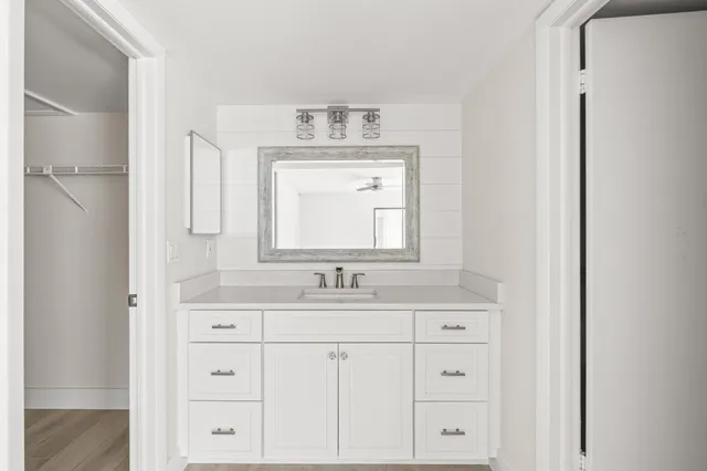 a bathroom with a double vanity sink and mirror