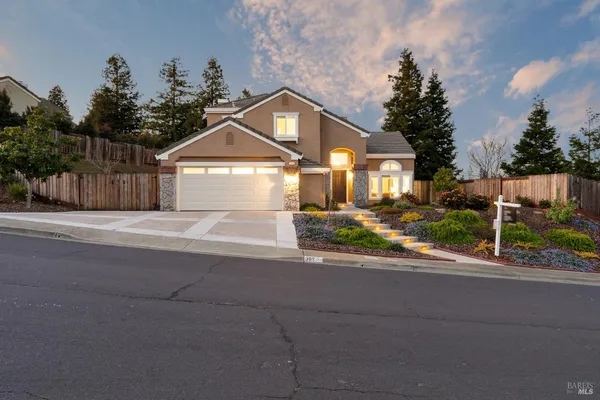 a front view of a house with a yard and a garage