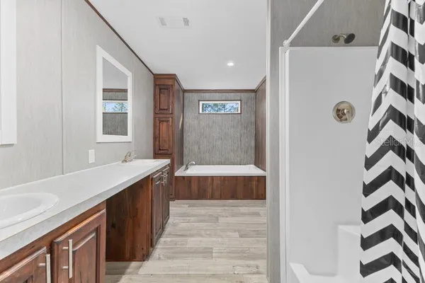 a spacious bathroom with a sink and a mirror