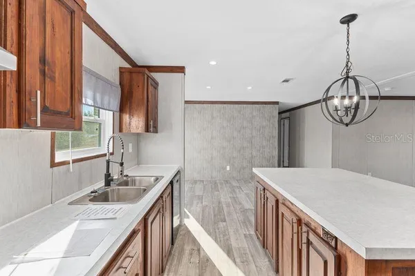 a kitchen with stainless steel appliances granite countertop a sink a stove and a refrigerator