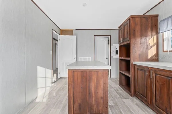 a view of walk in closet with wooden floor