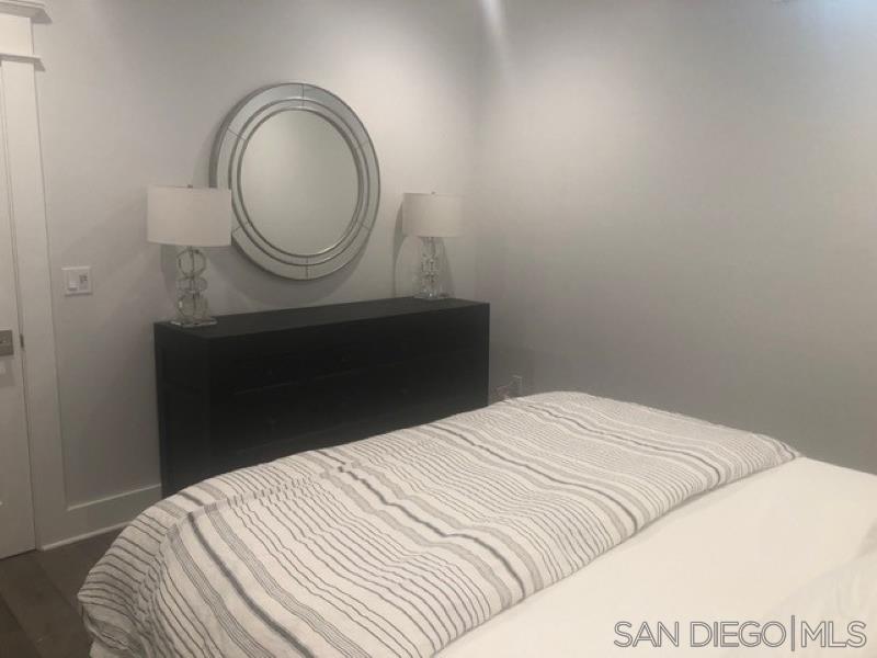 453 E Avenue Coronado, CA 92118 - Photo 13 of 16 a bedroom with a bed and a mirror