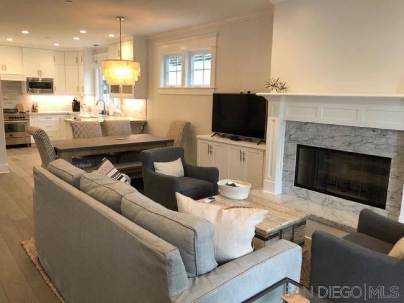 453 E Avenue Coronado, CA 92118 - Photo 3 of 16 a living room with furniture a flat screen tv and a fireplace