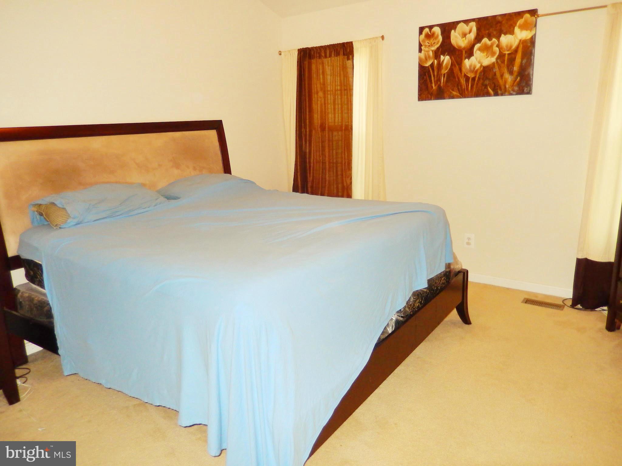1951 Waltman Road Edgewood, MD 21040 - Photo 11 of 20 a bed sitting in a bedroom next to a blue wall