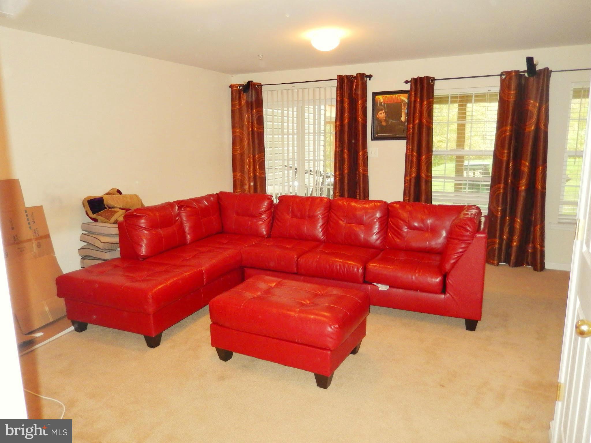1951 Waltman Road Edgewood, MD 21040 - Photo 16 of 20 a blue couch sitting in a living room next to a window