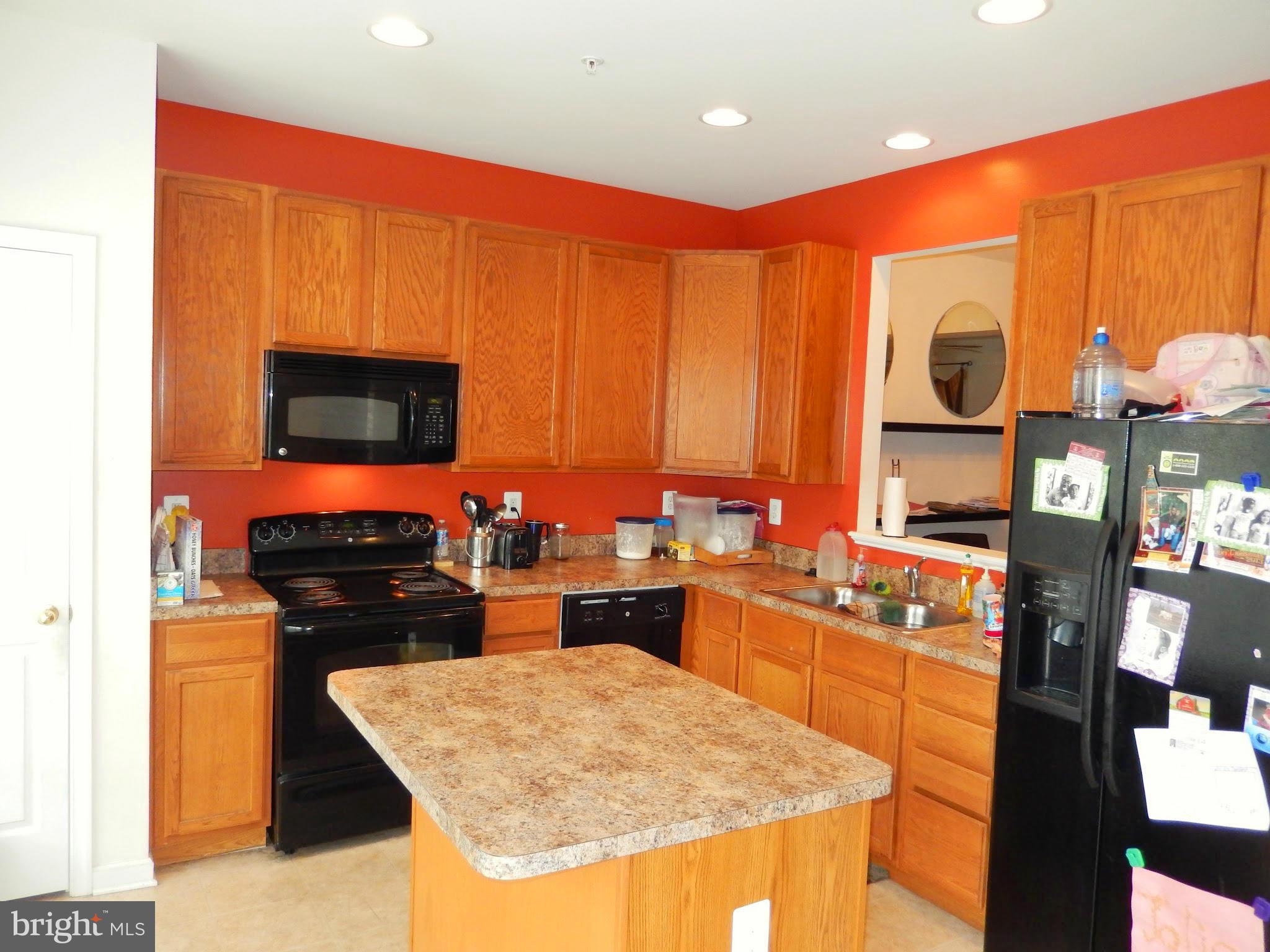 1951 Waltman Road Edgewood, MD 21040 - Photo 6 of 20 a kitchen with stainless steel appliances granite countertop a stove top oven microwave and refrigerator