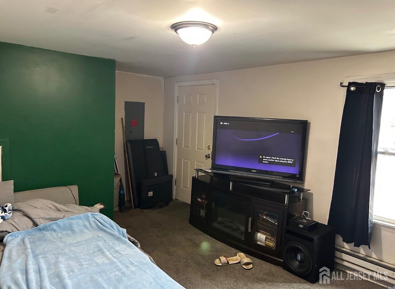 152 Broad Street Carneys Point, NJ 08069 - Photo 4 of 5 a bedroom with a bed and a flat screen tv