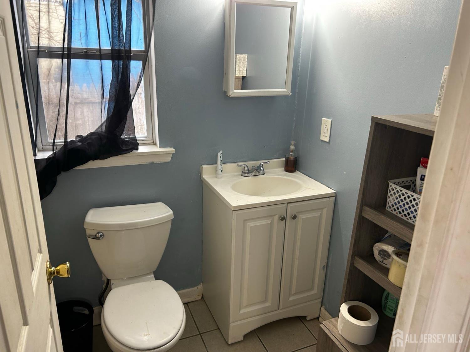 152 Broad Street Carneys Point, NJ 08069 - Photo 5 of 5 a white toilet sitting next to a bathroom sink