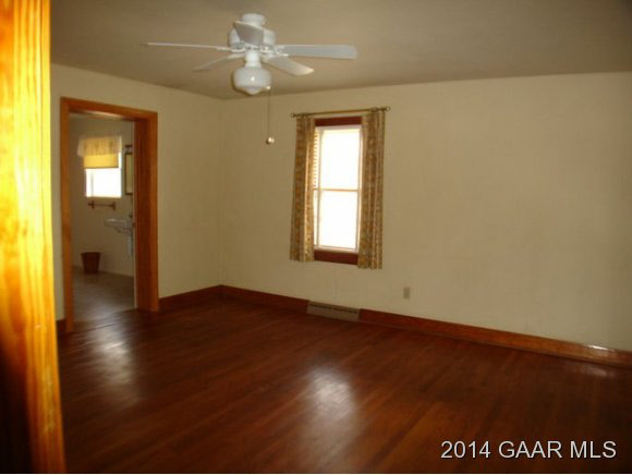 78 Haytie Road Swoope, VA 24479 - Photo 9 of 21 an empty room with wooden floor fan and windows