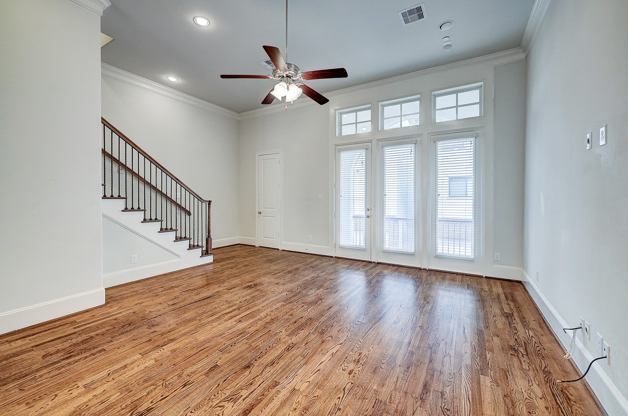 1110 Thompson Street Houston, TX 77007 - Photo 9 of 32 a view of an empty room with wooden floor and a window