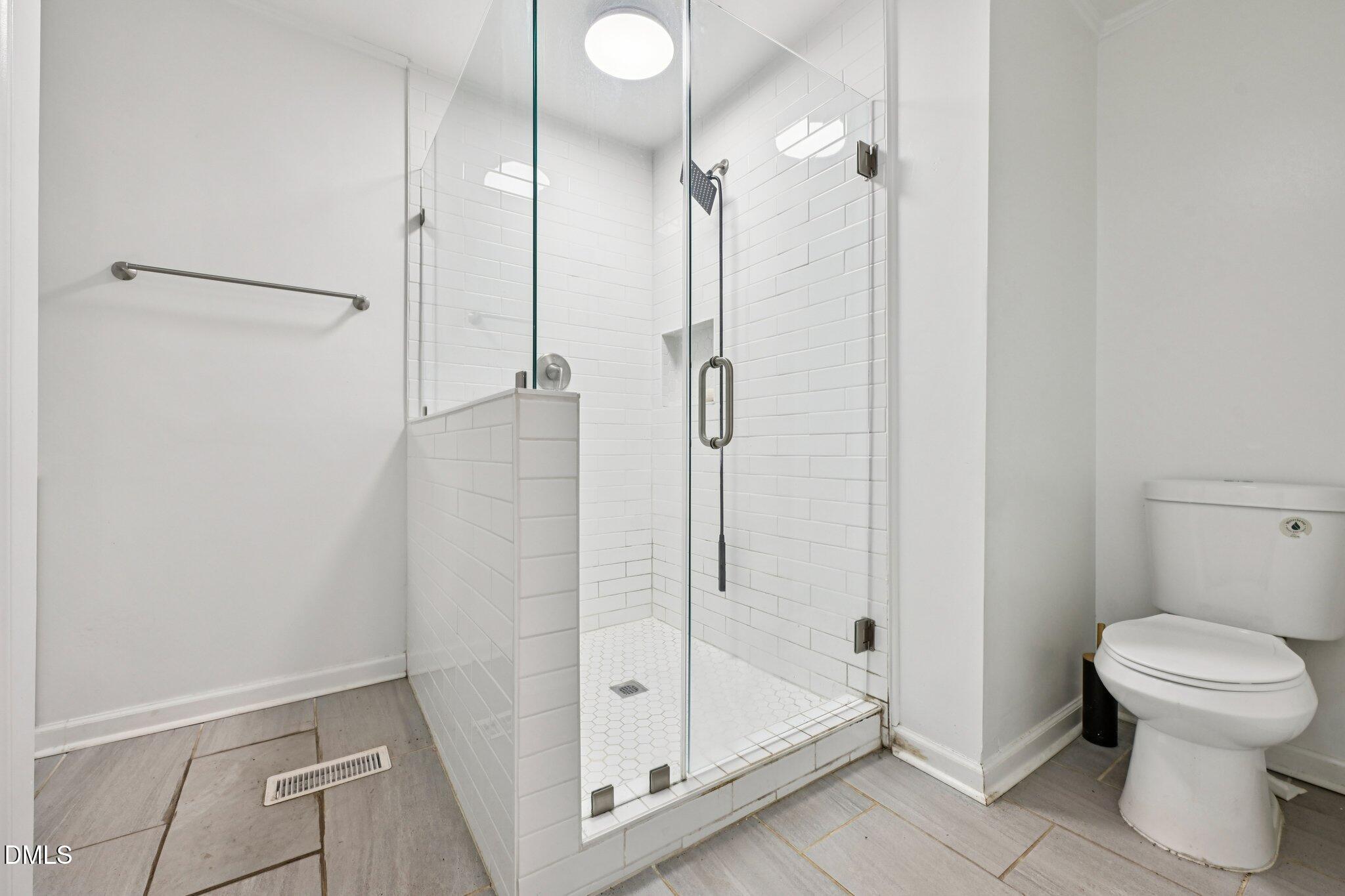131 Creech Road Garner, NC 27529 - Photo 12 of 18 a bathroom with a shower and toilet