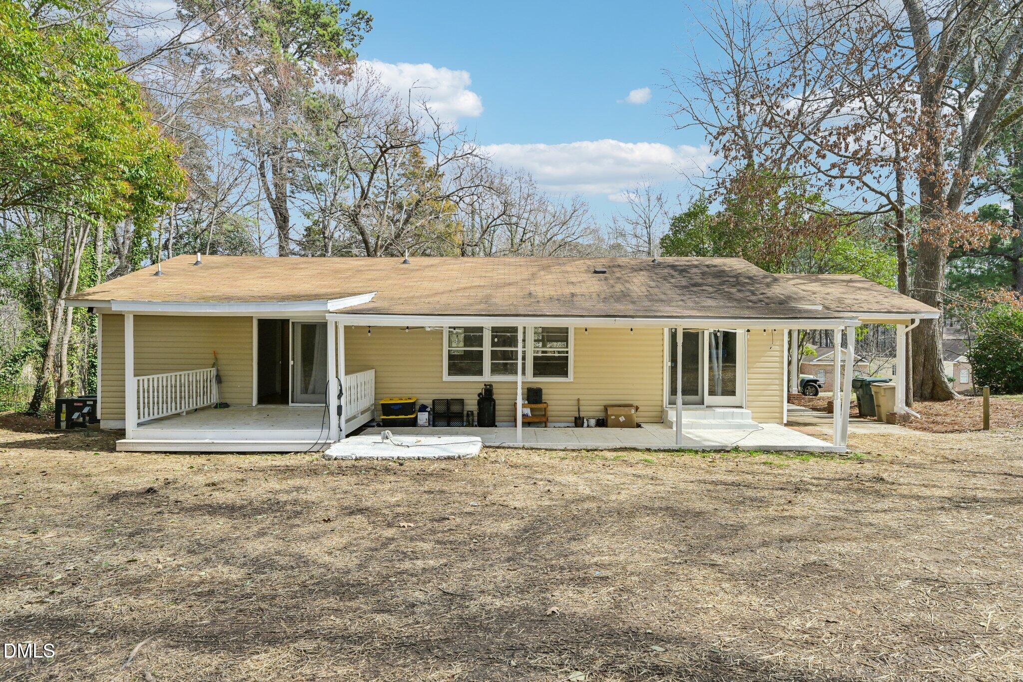 131 Creech Road Garner, NC 27529 - Photo 15 of 18 a front view of a house with a garden and trees