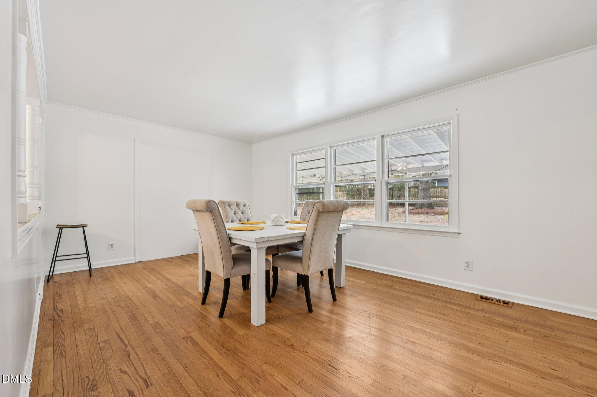 131 Creech Road Garner, NC 27529 - Photo 3 of 18 a dining room with furniture and wooden floor