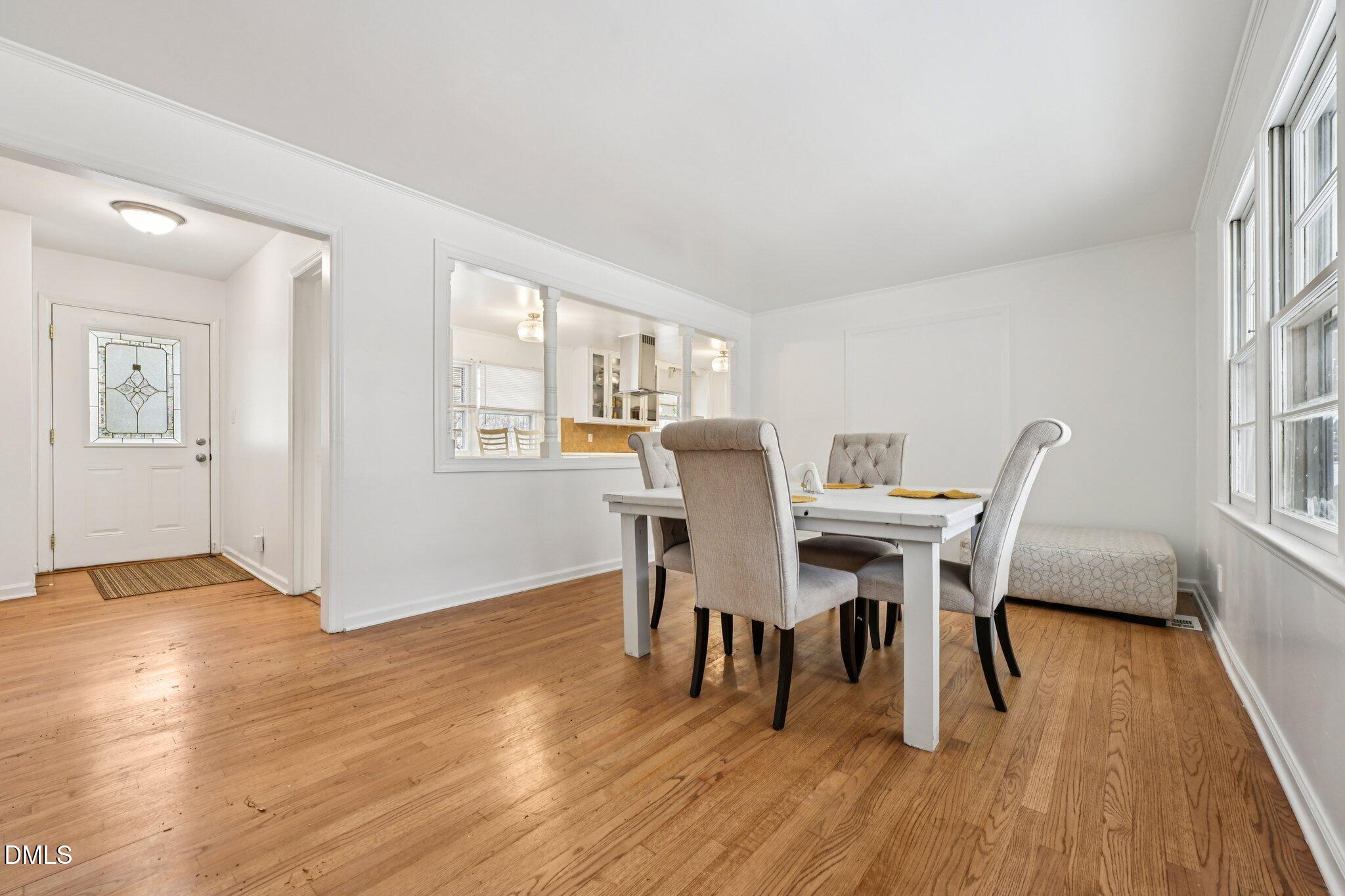 131 Creech Road Garner, NC 27529 - Photo 4 of 18 a view of a dining room with furniture and wooden floor