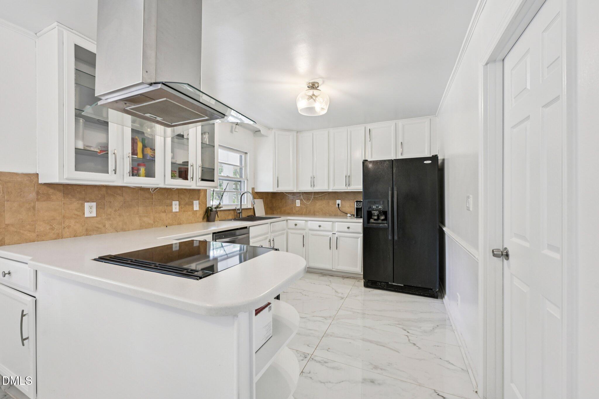 131 Creech Road Garner, NC 27529 - Photo 5 of 18 a kitchen with a refrigerator a stove a sink and a cabinets