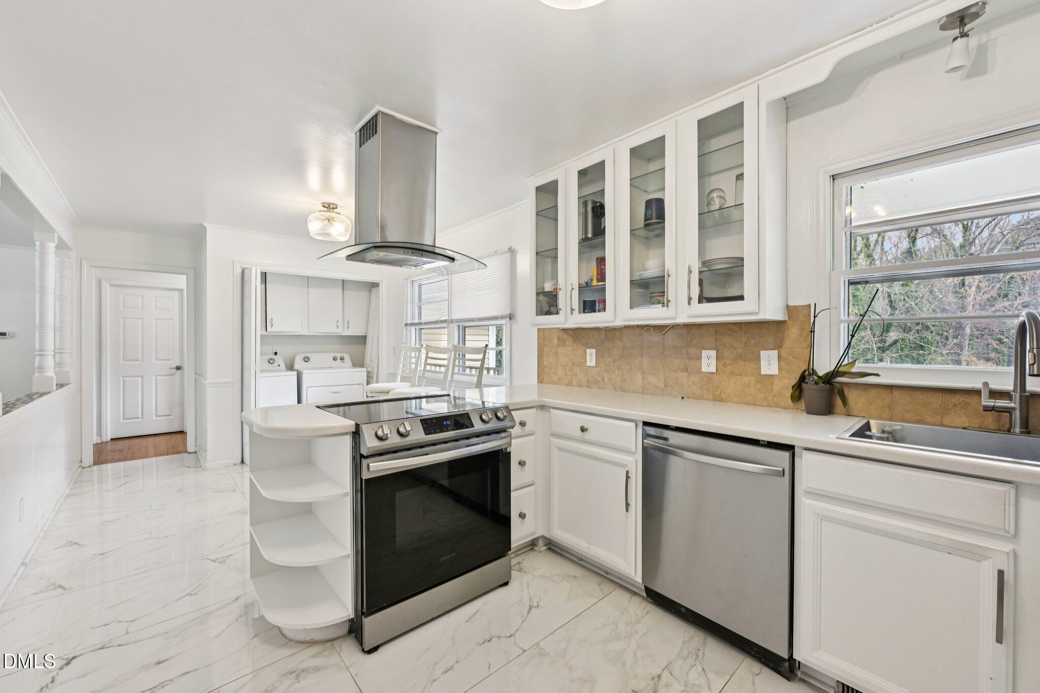 131 Creech Road Garner, NC 27529 - Photo 6 of 18 a kitchen with stainless steel appliances granite countertop a stove and a sink