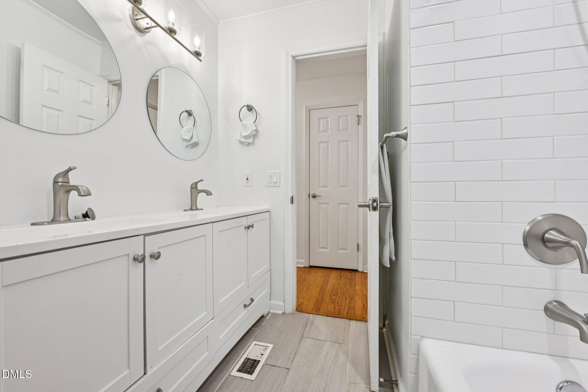 131 Creech Road Garner, NC 27529 - Photo 10 of 18 a spacious bathroom with a shower and a sink