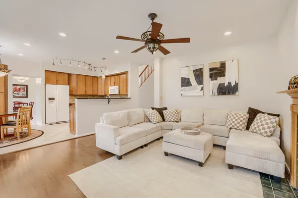 a living room with furniture and kitchen view