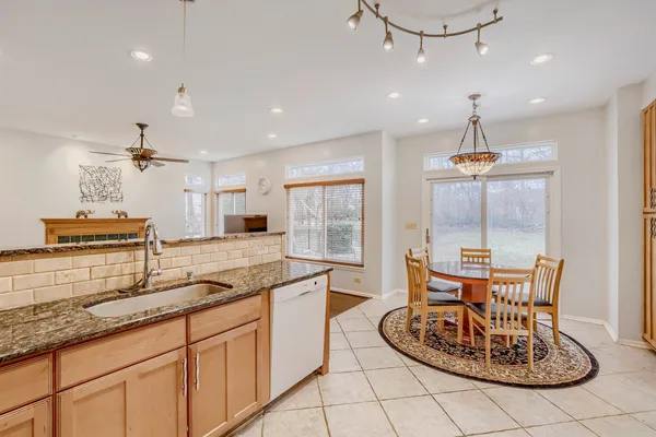 a kitchen with granite countertop kitchen island stainless steel appliances a sink and a center island