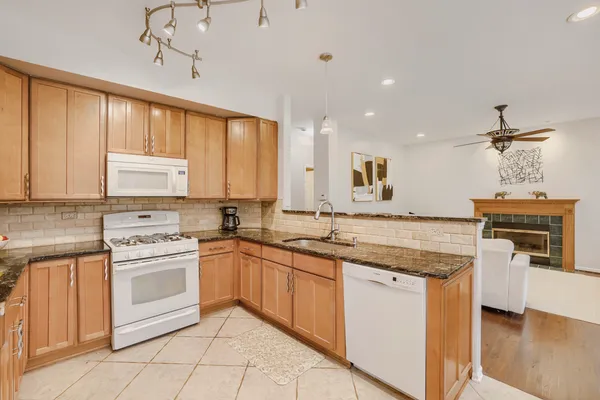 a kitchen with a stove sink and cabinets