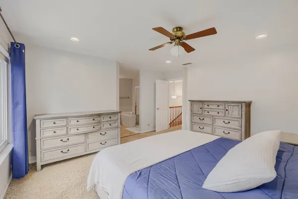 a bedroom with a bed and a chair
