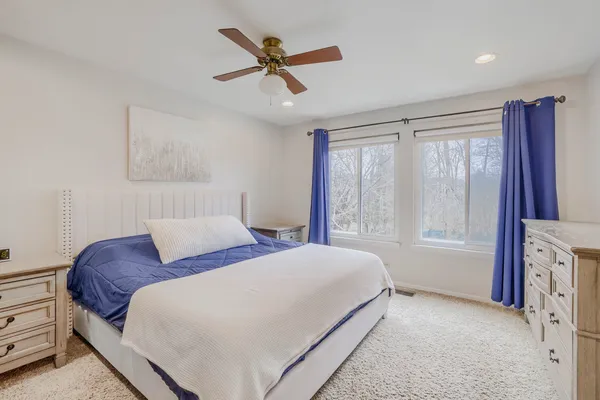 a bedroom with a large bed and a chandelier
