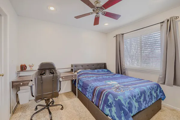a bedroom with a bed and a desk