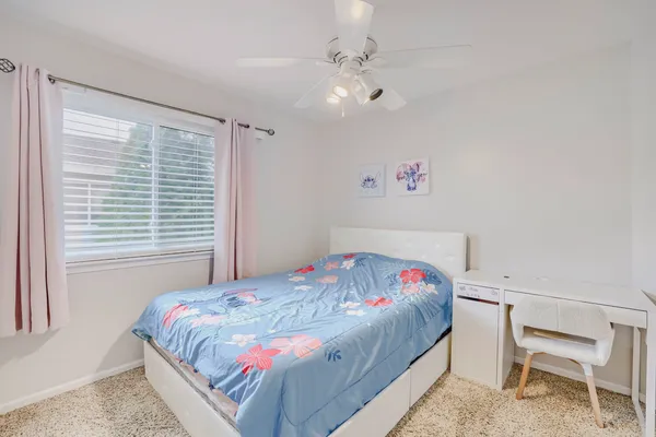 a bedroom with a bed and a table