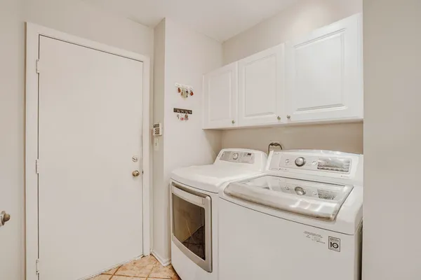 a view of washer and dryer with kitchen in the background