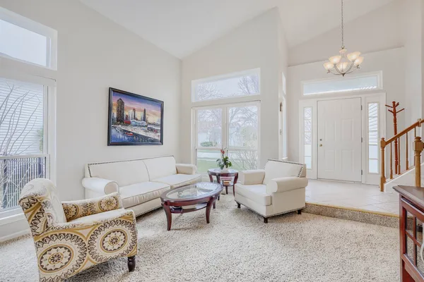 a living room with furniture and a baby crib
