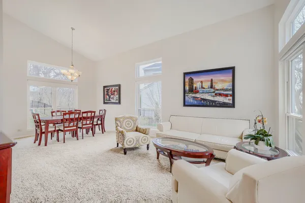 a living room with furniture a rug and a chandelier