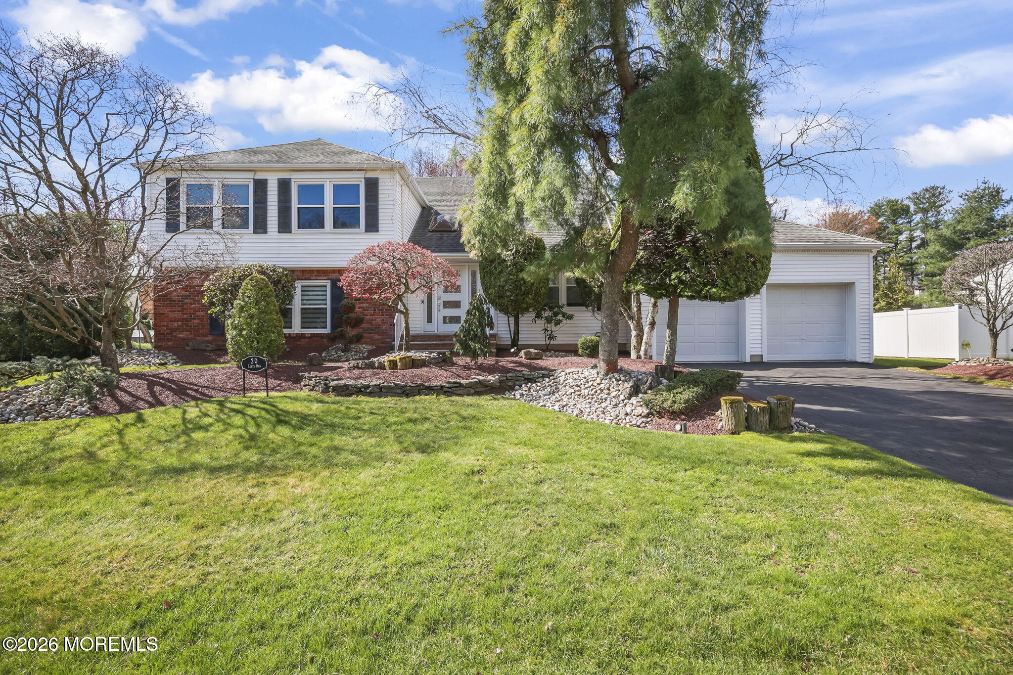 a view of a house with a yard patio and fire pit