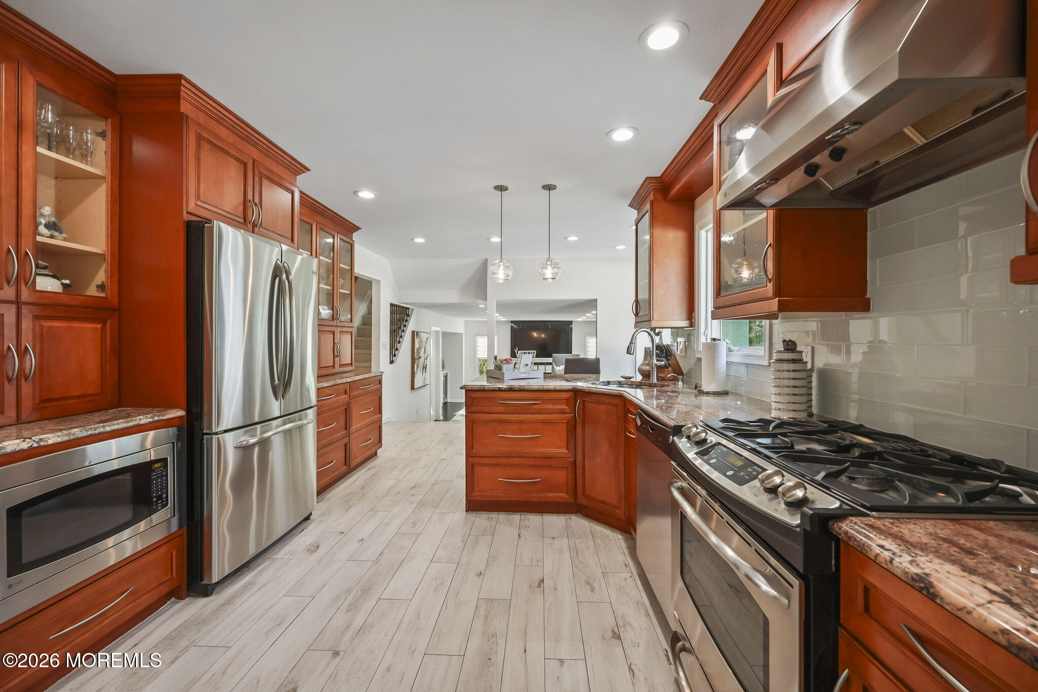 20 Colts Run Marlboro, NJ 07746 - Photo 21 of 44 a kitchen with stainless steel appliances granite countertop a stove top oven a refrigerator and a microwave oven with wooden floor