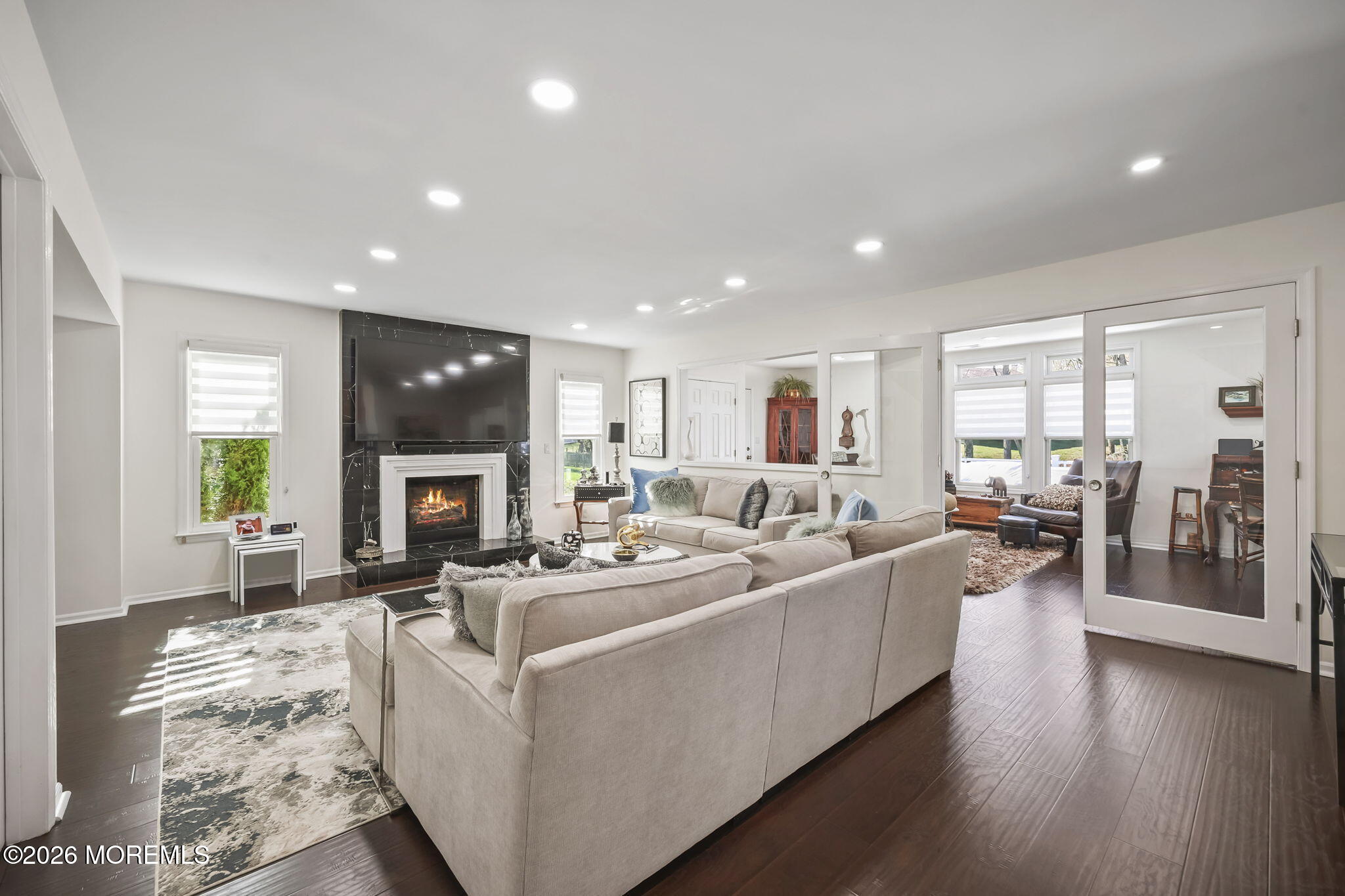 20 Colts Run Marlboro, NJ 07746 - Photo 5 of 44 a living room with furniture a fireplace a flat screen tv and a wooden floor