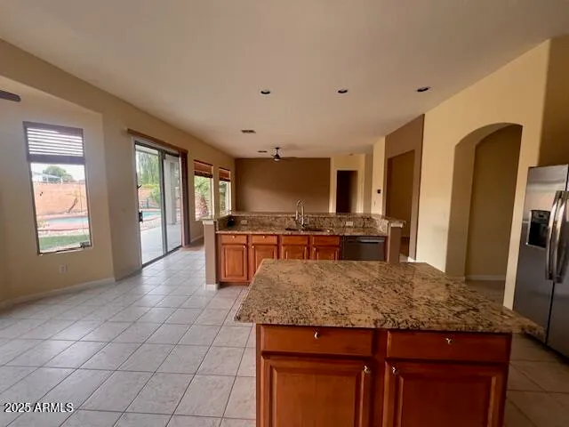 a kitchen with stainless steel appliances granite countertop a sink and cabinets