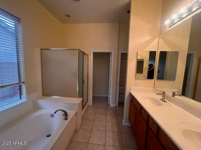 a bathroom with a tub sink and mirror