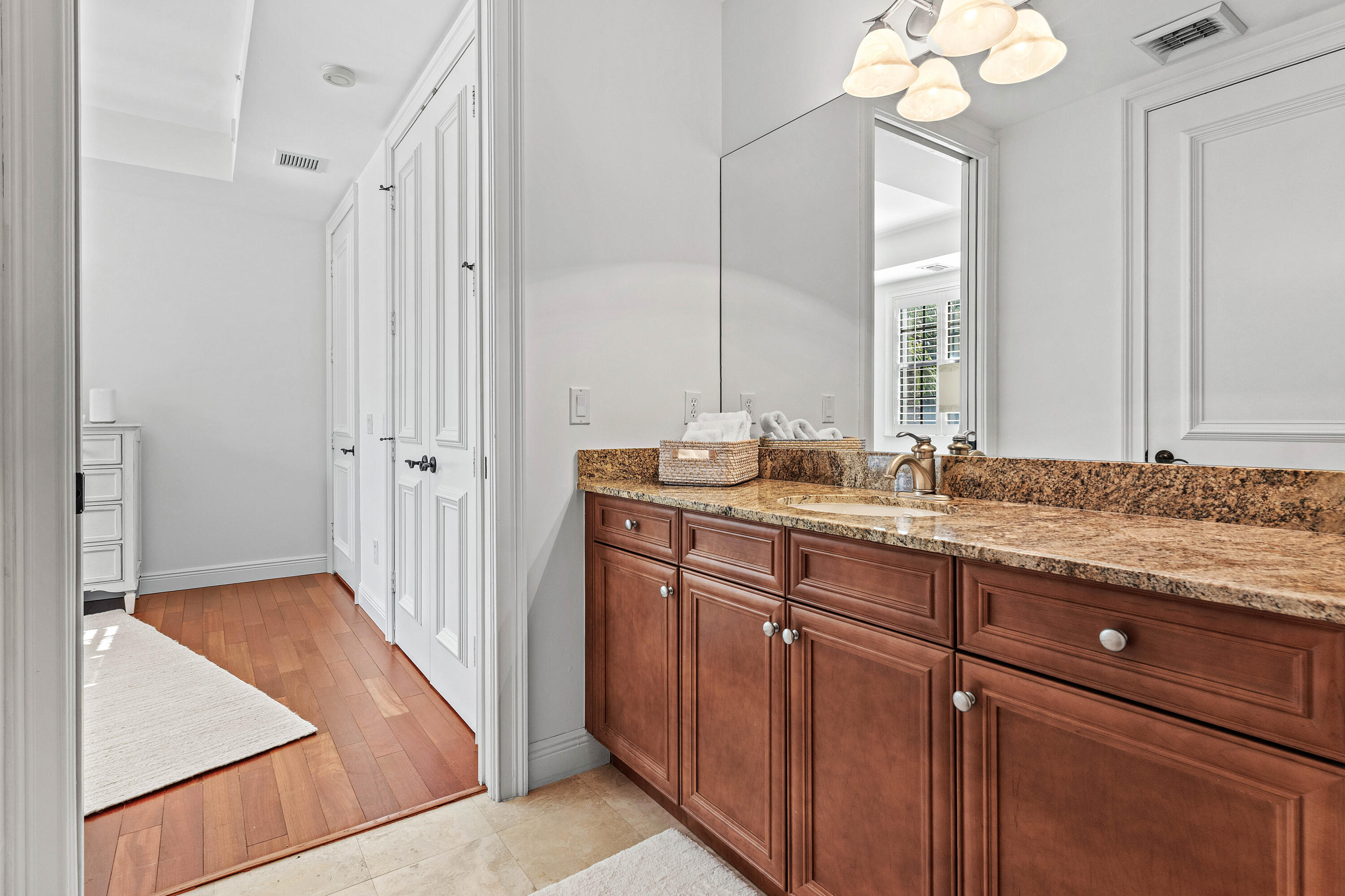 110 Gleason Street, Unit 203 Delray Beach, FL 33483 - Photo 18 of 25 a bathroom with a sink and a mirror