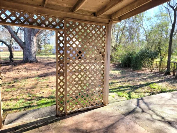a view of a yard with wooden fence