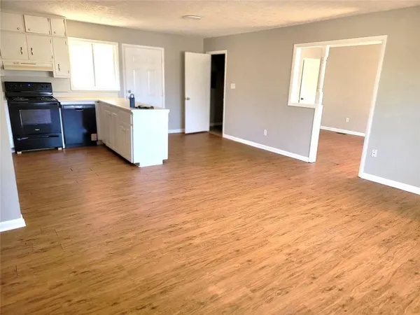 a view of a kitchen with furniture and windows