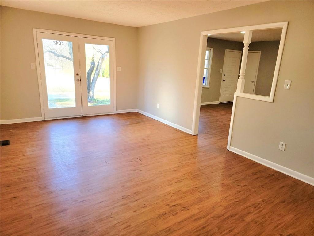 4042 Jodeco Road McDonough, GA 30253 - Photo 3 of 16 an empty room with wooden floor and windows