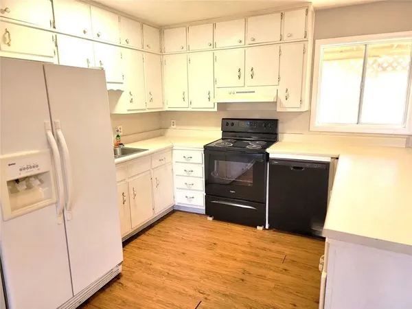 a kitchen with stainless steel appliances a refrigerator and a stove