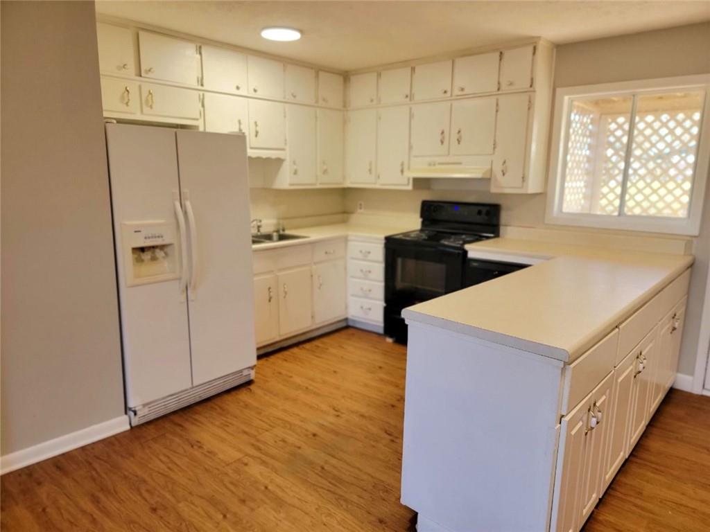 4042 Jodeco Road McDonough, GA 30253 - Photo 5 of 16 a kitchen with stainless steel appliances a refrigerator sink and cabinets