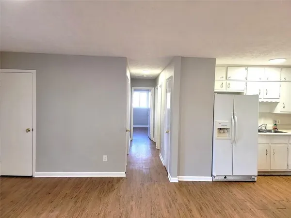 a view of a hallway with wooden floor