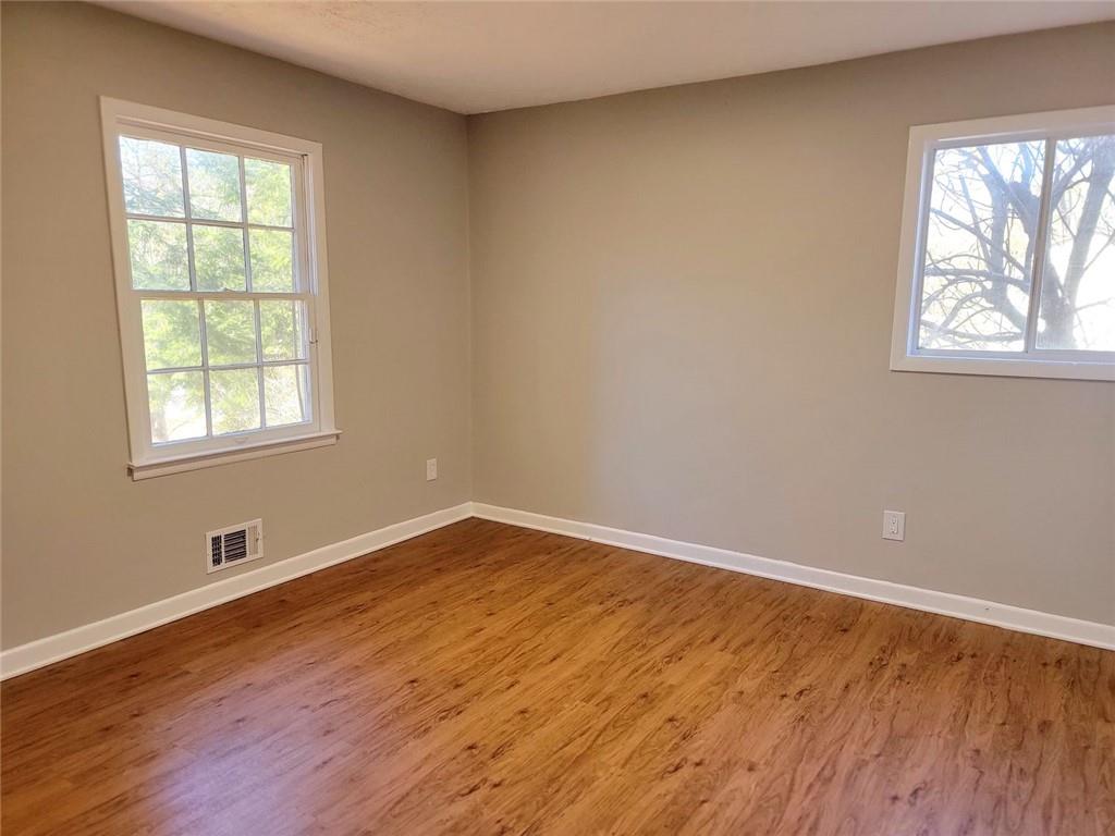 4042 Jodeco Road McDonough, GA 30253 - Photo 9 of 16 an empty room with wooden floor and windows