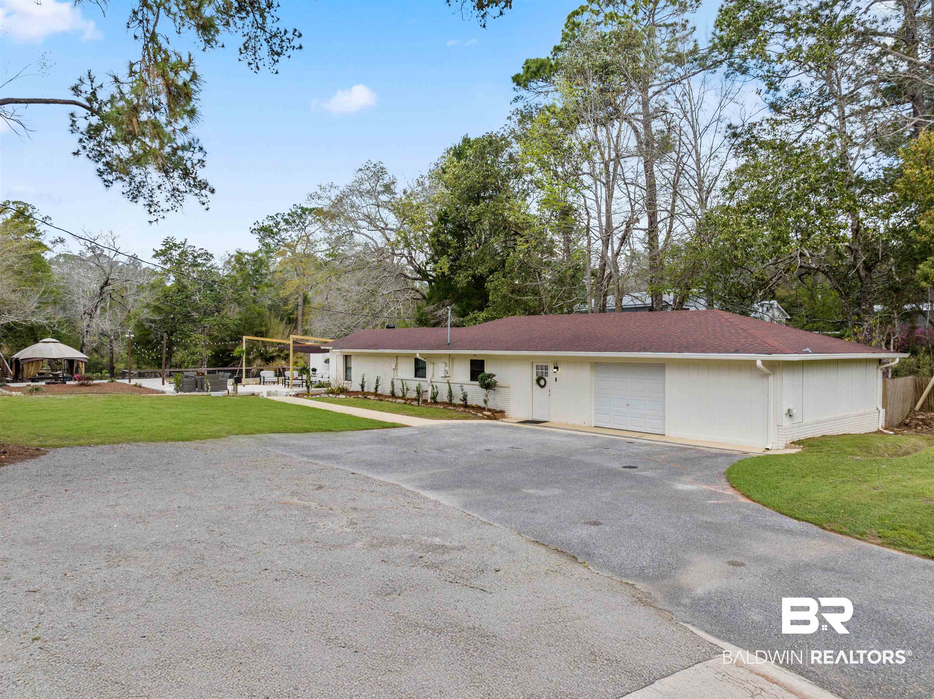 17595 River Road Summerdale, AL 36580 - Photo 22 of 29 Ranch-style house with asphalt driveway, view of wooded area, and an attached garage